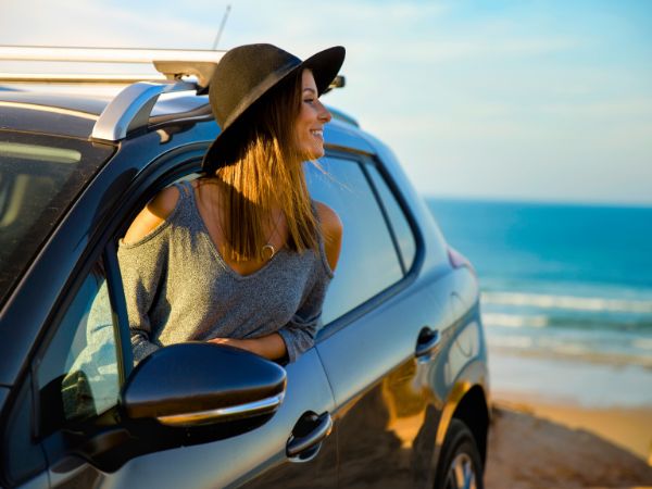 Woman with Rental Car at the Beach