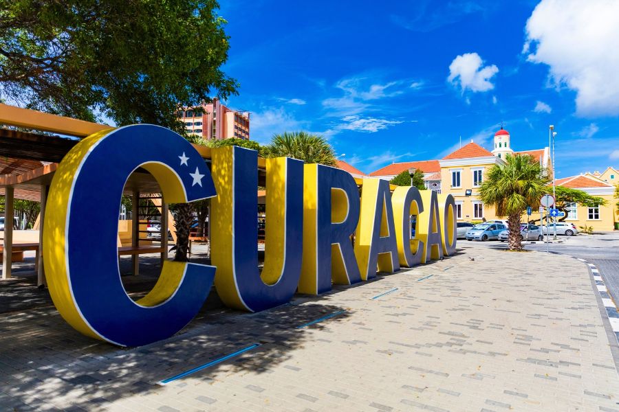 Compact car driving through Curaçao’s narrow city streets.